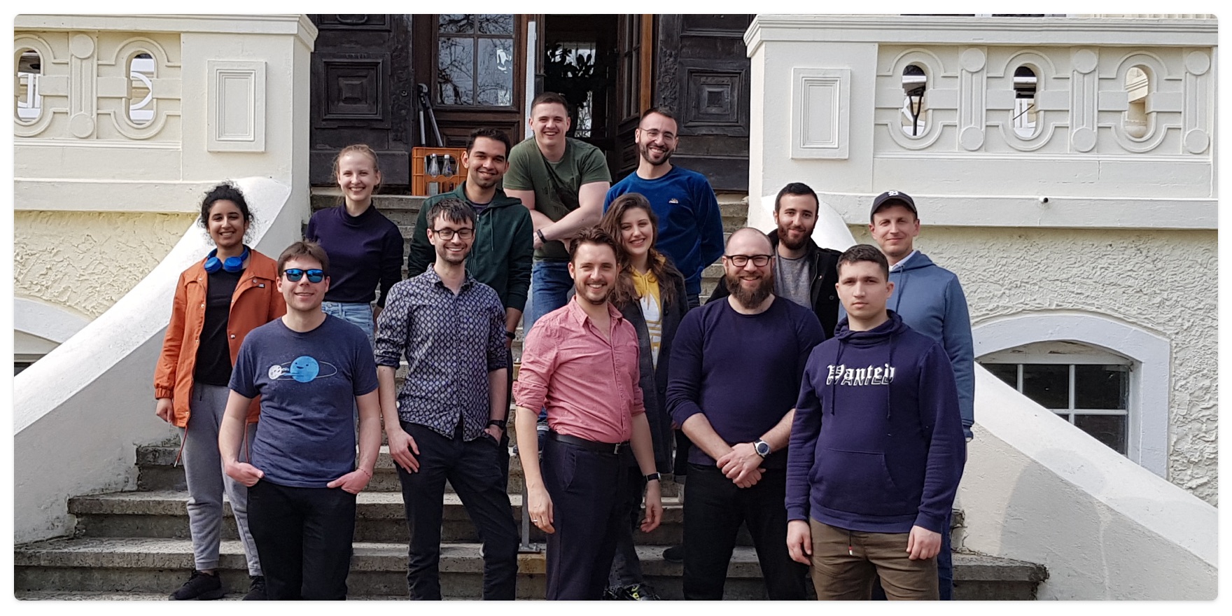 A photo of the SmileBack team standing on steps outside a building